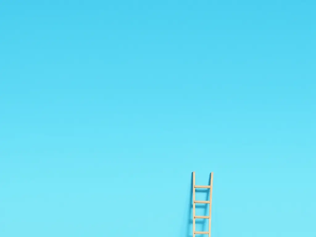 A wooden ladder leaning against a clear blue sky, symbolizing step-by-step progress toward fitness goals.